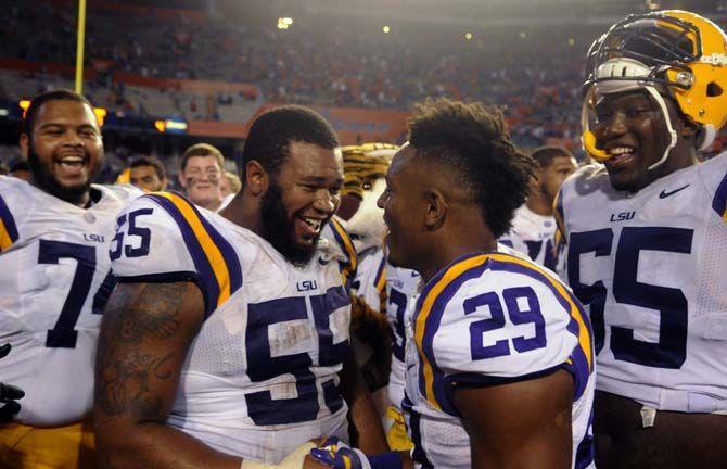 LSU senior center Elliott Porter (55) congratulates sophomore saftey Rickey Jefferson (29) Saturday, October 11, 2014 during the Tigers' 30-27 victory in Ben Hill Griffin Stadium.