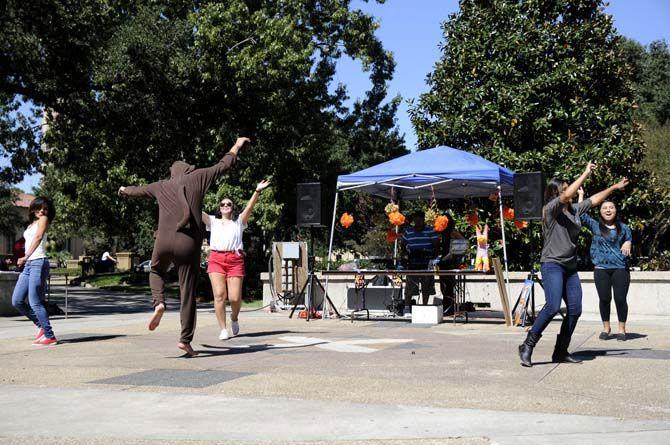 Members of the Hispanic Student Cultural Society and Phi Lota Alpha fraternity dance to hispanic music on Tuesday at Free Speech Plaza.