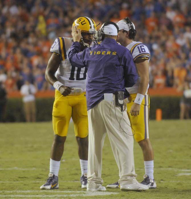 LSU head coach Les Miles prepares sophomore quarterback Anthony Jennings (10) for a play Saturday, October 11, 2014 during the Tigers' 30-27 victory in Ben Hill Griffin Stadium.