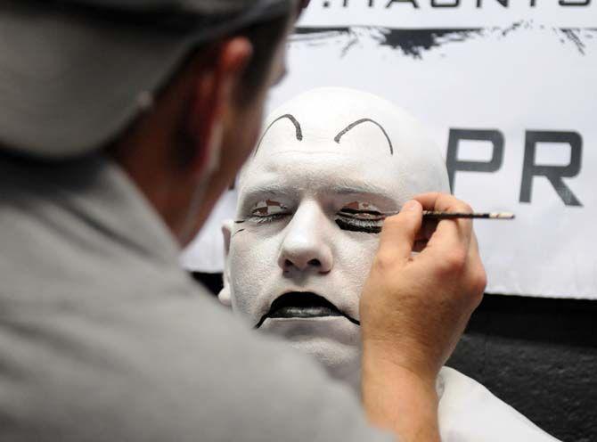 Actors sit backstage to get their makeup done for their role in the 13th Gate.