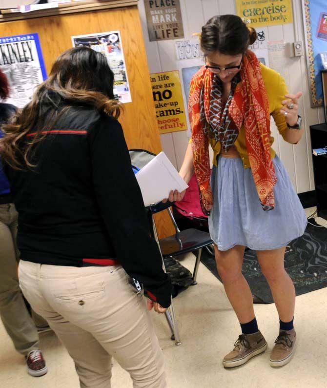English secondary education senior Gabrielle Swindle dances with students in the break dancing corner during a group exercise Wednesday October 22, 2014 at McKinley high school.