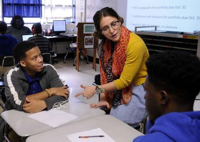 English secondary education senior Gabrielle Swindle explains why a rap battle is poetry in its own way to students during a group exercise Wednesday October 22, 2014 at McKinley high school.