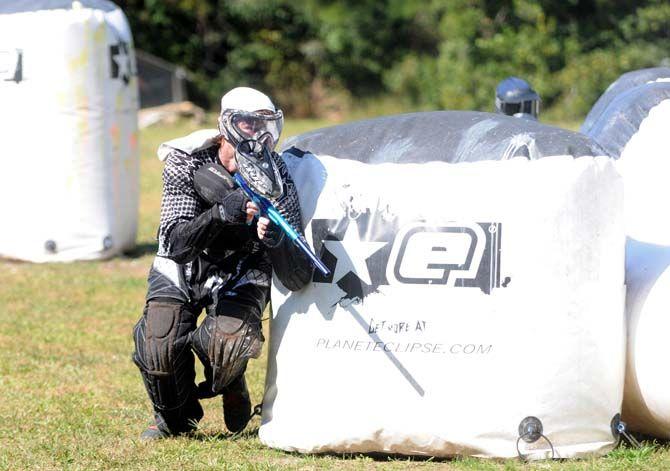 Team member of LSU's Tiger Paintball, Brett Taliaferro, crouches behind an inflatable wall in a round of speedball at Paintball Command in Mandeville Sunday, October 19, 2014.