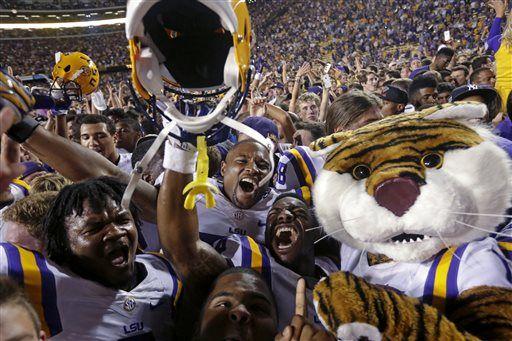 LSU players celebrate with swarming fans after defeating Mississippi in an NCAA college football game in Baton Rouge, La., Saturday, Oct. 25, 2014. LSU won 10-7. (AP Photo/Gerald Herbert)