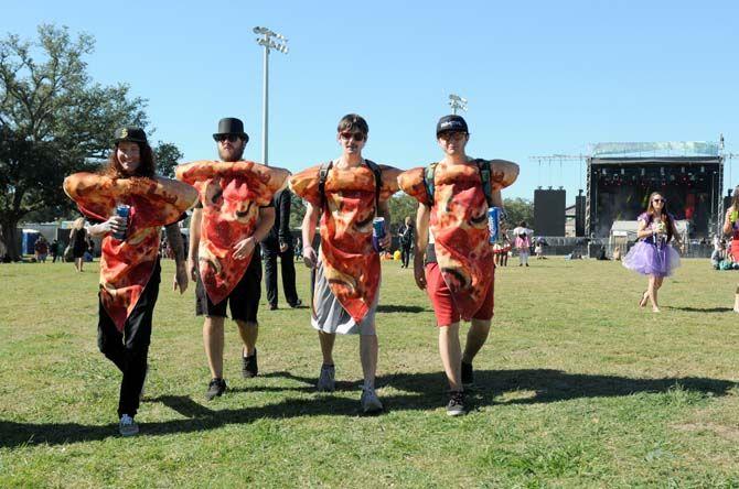 Men dressed up as pizza slices walk the festival grounds at VooDoo Music Experience Friday, October 31, 2014.