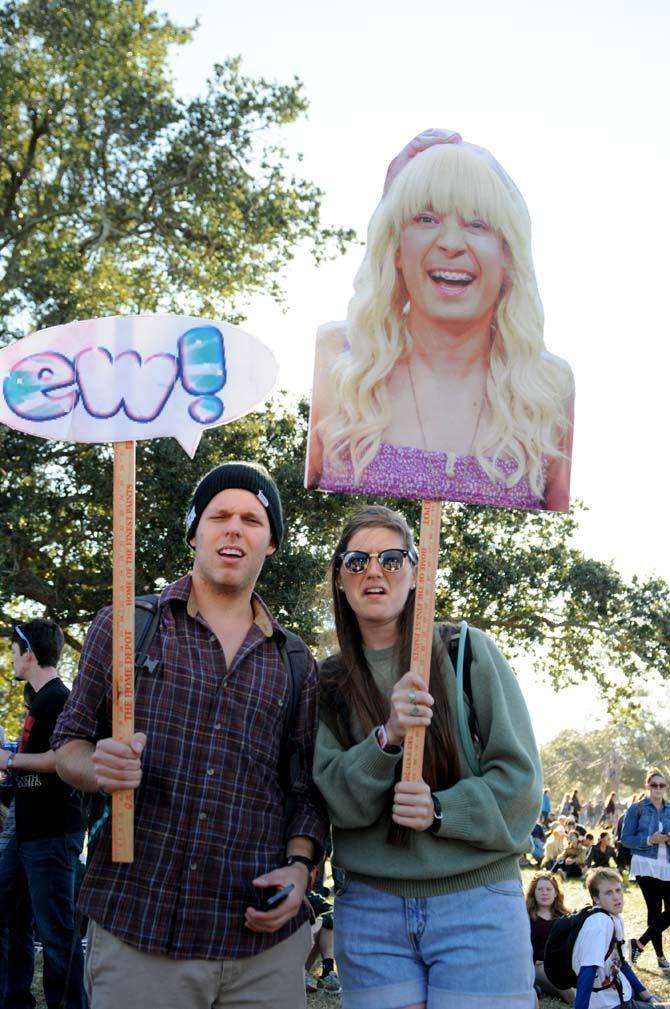 Festival goers bring signs to hold in the crowd at VooDoo Music Festival Saturday, November 1, 2014 in New Orleans.