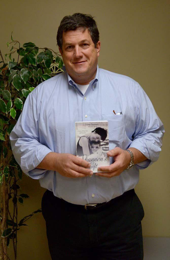 GSU professor Dr. Nate Bennett hold a copy of 'Shannon's Gift' Tuesday, November 18, 2014 before speaking about his novel.