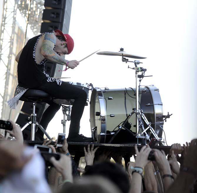 Twenty One Pilots drummer, Josh Dunn, drums on a platform supported by the crowd during their setlist at the Voodoo Music Experience Friday, October 31, 2014.