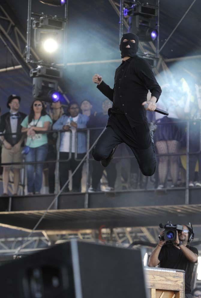Twenty One Pilots lead singer, Tyler Joseph, jumps off a piano during their setlist at The Voodoo Music Experience Friday, October 31, 2014.
