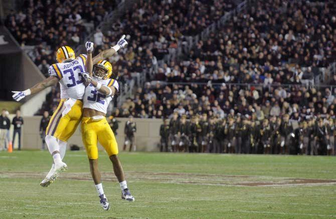 LSU junior cornerback Jalen Collins (32) and freshman safety Jamal Adams (33) celebrate after they forced a fumble during the Tigers' 23-17 victory on Thursday, Nov.27, 2014 in Kyle field.