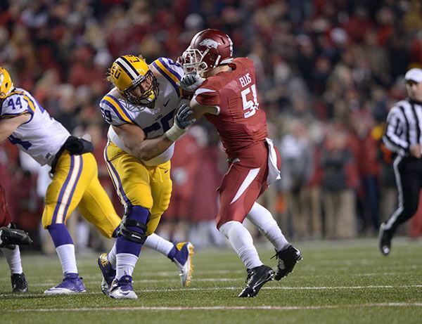 LSU senior offensive guard Fehoko Fanaika (69) blocks Arkansas line backer Brooks Ellis (51) in Tigers' losing game 17-0 Saturday, Nov. 15, 2014 in Razorback Staidum.