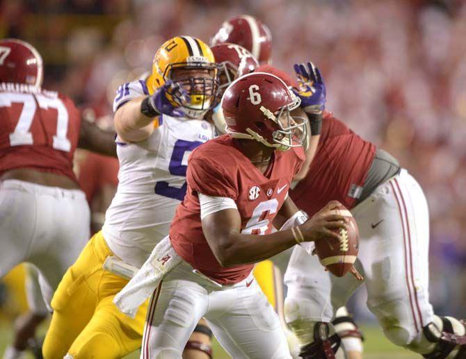 LSU sophomore defensive tackle Christian LaCouture (91) lunges for Alabama senior quarterback Blake Sims (6) Saturday, Nov. 8, 2014 during the Tigers' 20-13 loss against the Crimson Tide in Tiger Stadium.