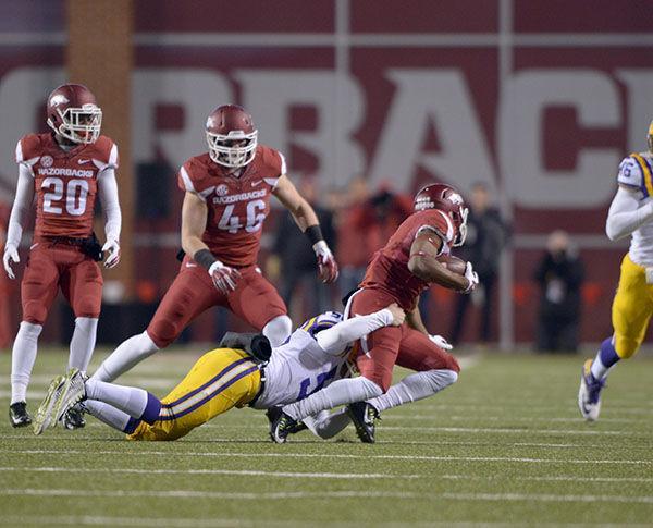 Arkansas freshman wide receiver Jared Cornelius (1) gets tackled by LSU snapback Reid Ferguson in Donald W. Reynolds Razorback Stadium Saturday, Nov. 15, 2014.