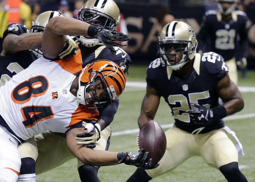 Cincinnati Bengals tight end Jermaine Gresham (84) fumbles into the end zone in front of New Orleans Saints free safety Rafael Bush (25) in the first half of an NFL football game in New Orleans, Sunday, Nov. 16, 2014. The Bengals recovered the ball in the end zone for a touchdown. (AP Photo/Bill Haber)