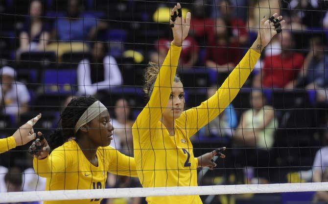 LSU junior outside hitter Emily Ehrle and freshman outside hitter Gina Tillis (12) prepare for a play during Tiger's victory 3-2 against Arkansas Sunday, October 5, 2014 in the PMAC.