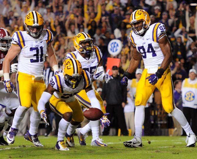 LSU senior linebacker D.J. Welter (31), senior safety Ronald Martin (26) and junior defensive end Danielle Hunter watch as junior defensive back Jalen Mills (28) attempts to recover the ball Saturday, November 8, 2014 during the Tigers' 20-13 loss against the Crimson Tide in Tiger Stadium.