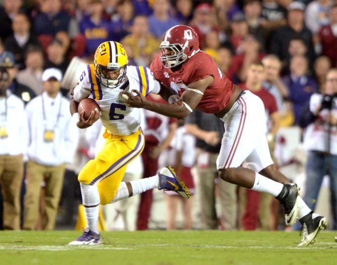 LSU freshman quarterback Brandon Harris (6) fights off an Alabama defender Saturday, Nov. 8, 2014 during the Tigers' 20-13 loss against the Crimson Tide in Tiger Stadium.