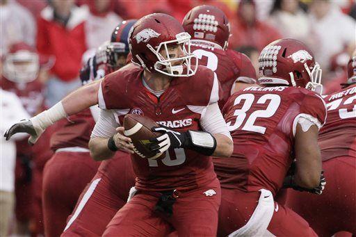 Arkansas quarterback Brandon Allen, center, looks for a receiver in the second quarter of an NCAA college football game against Mississippi Saturday, Nov. 22, 2014, in Fayetteville, Ark. (AP Photo/Danny Johnston)