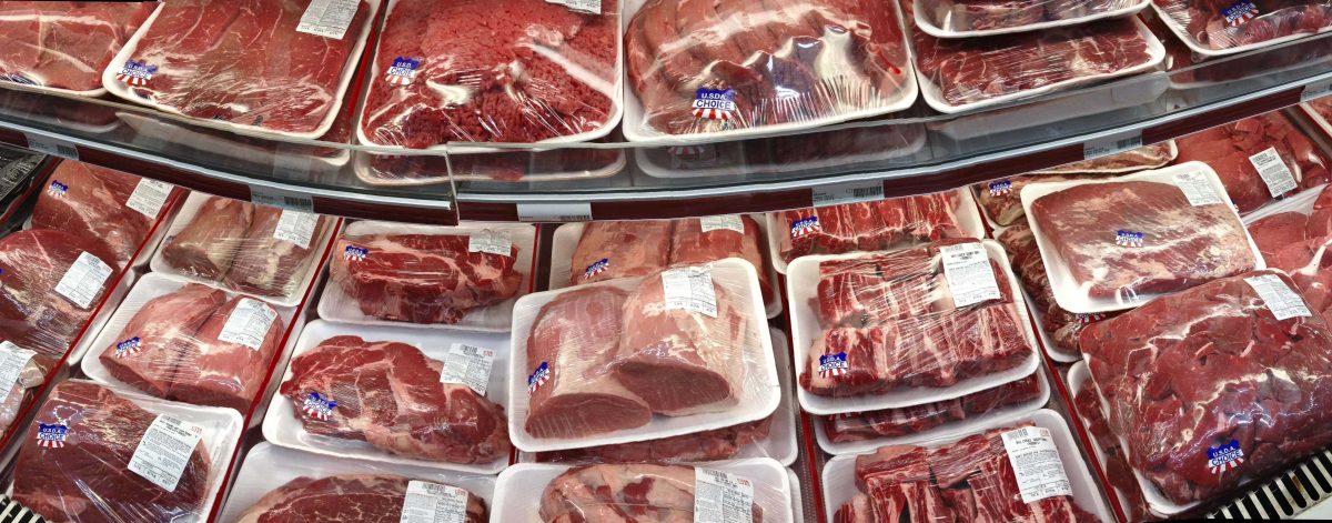 FILE - In this Nov. 2, 2013 file photo, various cuts of beef and pork are displayed for sale in the meat department at a discount market in Arlington, Va. The U.S. is running out of options to keep package labels on fresh cuts of meat that identify where animals were born, raised and slaughtered. The World Trade Organization has ruled that those labels discriminate against Canada and Mexico. (AP Photo/J. Scott Applewhite, File)