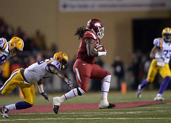 Arkansas running back Alex Collins (3) escapes tackle in Razorbacks' winning game 17-0 Saturday, Nov. 15, 2014 in Donald W. Reynolds Razorback Stadium.