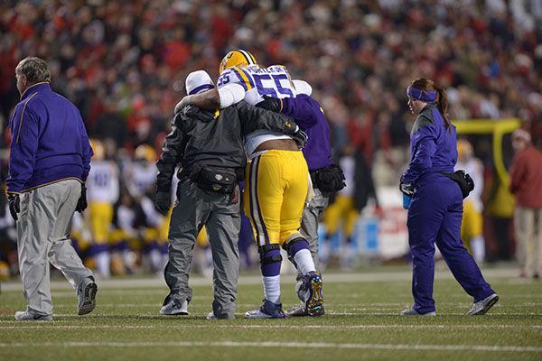 LSU Senior center Elliot Porter (55) exits field after being injured in game against Arkansas in Donald W. Reynolds Razorback Stadium Saturday, Nov. 15, 2014.