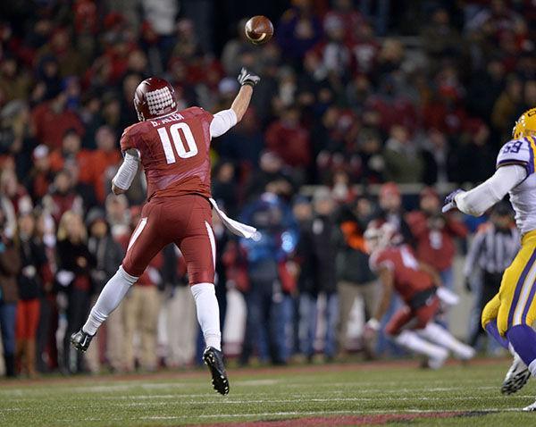 Arkansas quarterback Brandon Allen (10) jumps to catch the ball in Razorbacks' winning game 17-0 Saturday, Nov. 15, 2014 in Razorback Stadium.