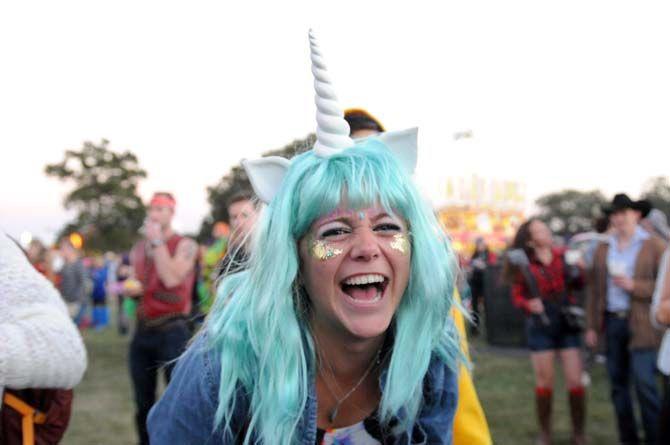 Festival goer dressed as a unicorn dances during Bleachers' set at VooDoo Music Experience Friday, October 31, 2014.