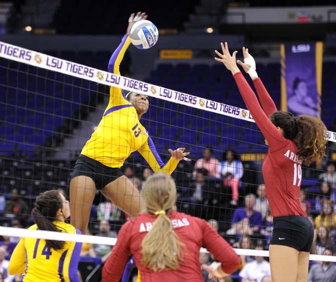 LSU freshman middle blocker Briana Holman (13) spikes the ball Sunday, October 27, 2013 during the Tigers' 3-2 victory against Arkansas at the PMAC.