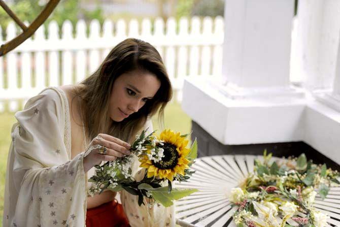 Bonnie Campbell adjusts one of her flower corwns that she uses for her fashion line Scar.