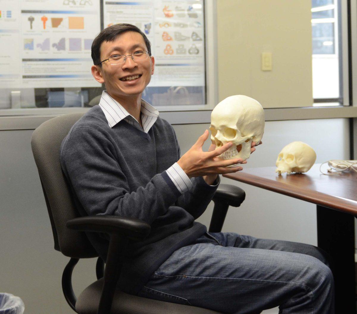 Xin (Shane) Li does research with 3D scanners and 3D printers for skull reconstruction at the Digital Media Center November 17, 2014.