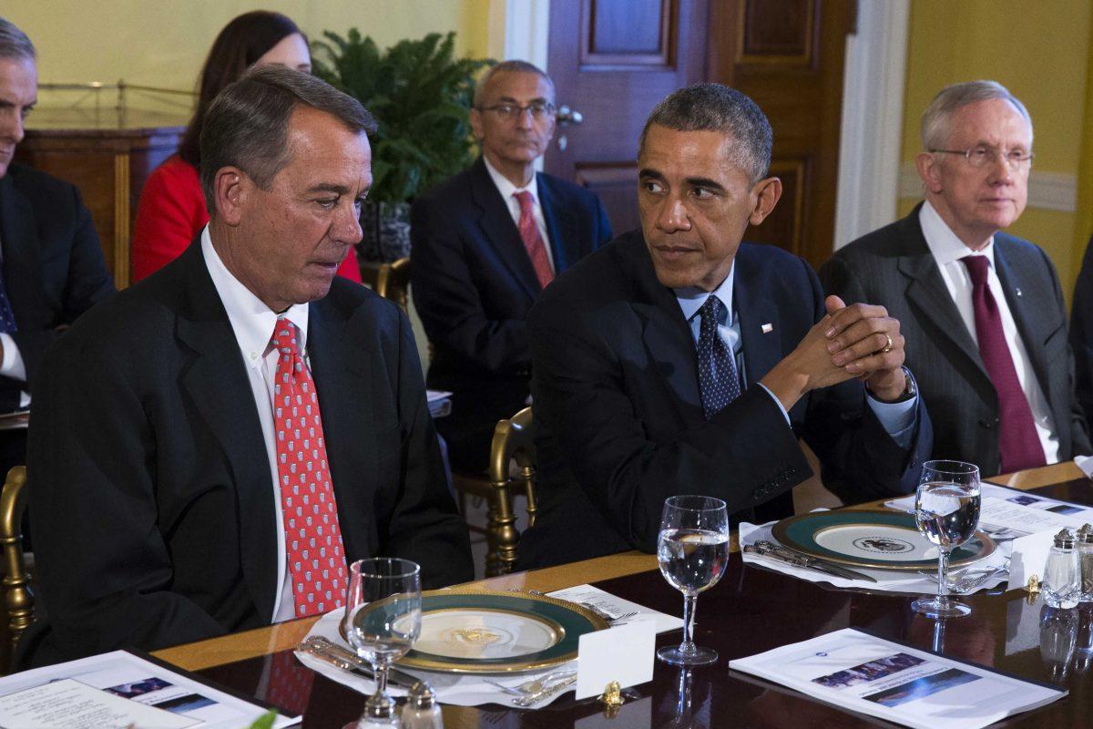 President Barack Obama meets with Congressional leaders in the Old Family Dining Room of the White House in Washington, Friday, Nov. 7, 2014. From left are, House Speaker John Boehner of Ohio, Obama, and Senate Majority Leader Harry Reid of Nev. (AP Photo/Evan Vucci)