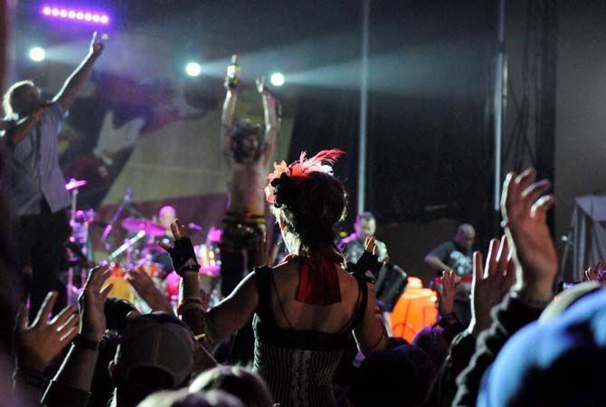 A fan on stilts watches Gogol Bordello at the Carnival stage Sunday, November 2, 2014 in New Orleans.