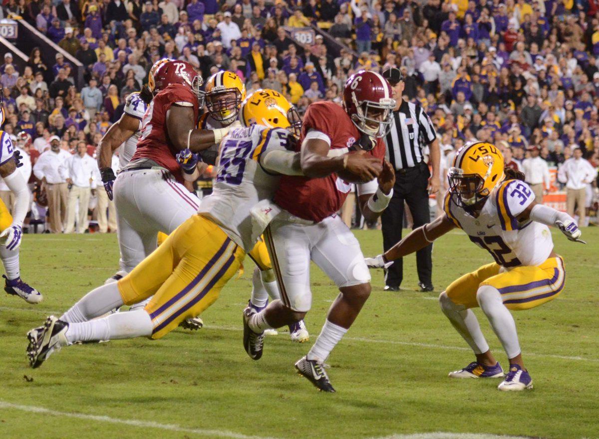 LSU Football player Jermaurie Rasco (#59) and Jalen Collins (#32) haults Alabama player in the LSU vs Alabama game at Tiger Stadium Saturday night, 20-13 lost to Alabama, November 8, 2014.