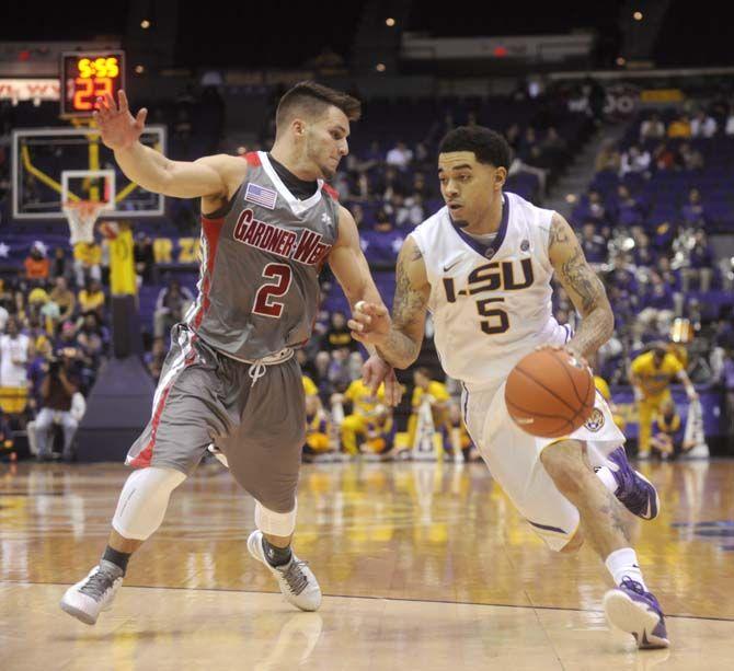 LSU junior guard Josh Gray (5) runs past defending senior guard Tyler Strange (2) during Tigers' 93-82 victory over Gardner-Webb on Saturday, Nov. 15, 2014 in the PMAC.