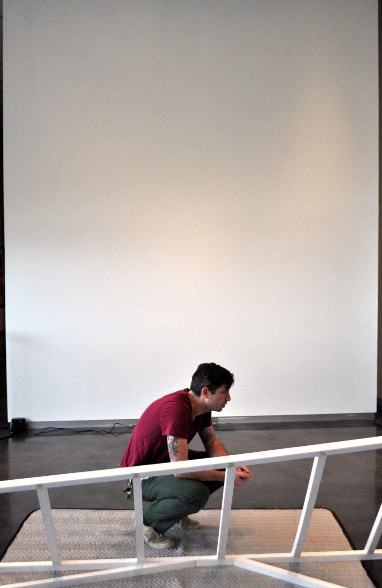 Local artist Silas Breaux works on his new installation, Dwelling, at the LSU Museum of Art on Wednesday.