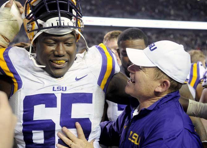 LSU sophomore offensive tackle Jerald Hawkins (65) smiles with head coach Les Miles after the Tigers' 23-17 victory on Thursday, Nov.27, 2014 in Kyle field.