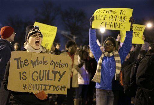 Protesters block streets after the announcement of the grand jury decision, Monday, Nov. 24, 2014, in St. Louis, Mo. A grand jury has decided not to indict Ferguson police officer Darren Wilson in the shooting death of 18-year-old Michael Brown. (AP Photo/Jeff Roberson)