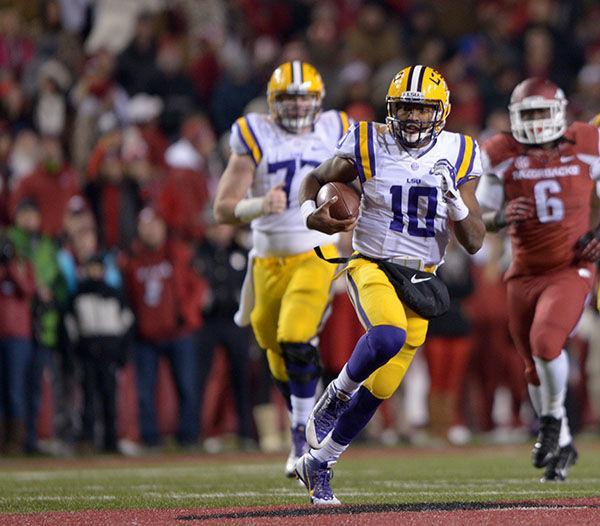 LSU sophomore quarterback Anthony Jennings (10) runs the ball down the field in Tigers' loss against Arkansas 17-0 Saturday, Nov. 15, 2014 in Donald W. Reynolds Razorback Stadium.