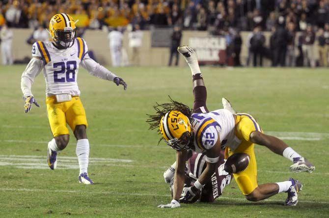 LSU junior cornerback Jalen Collins (32) tackles Texas A&amp;M senior wide receiver Malcome Kennedy (84) for an attempted fumble during the Tigers' 23-17 victory on Thursday, Nov.27, 2014 in Kyle field.