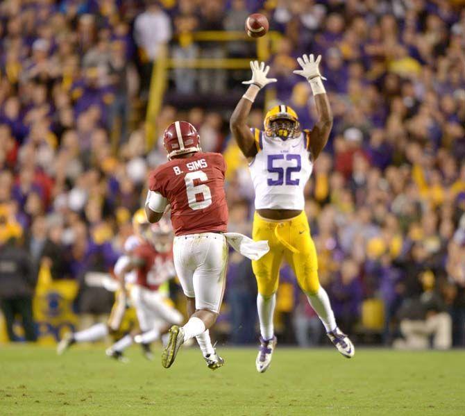 LSU sophomore linebacker Kendell Beckwith (52) attempts to block a pass by Alabama senior quarterback Blake Sims (6) during the Tigers' 20-13 loss against the Crimson Tide in Tiger Stadium.