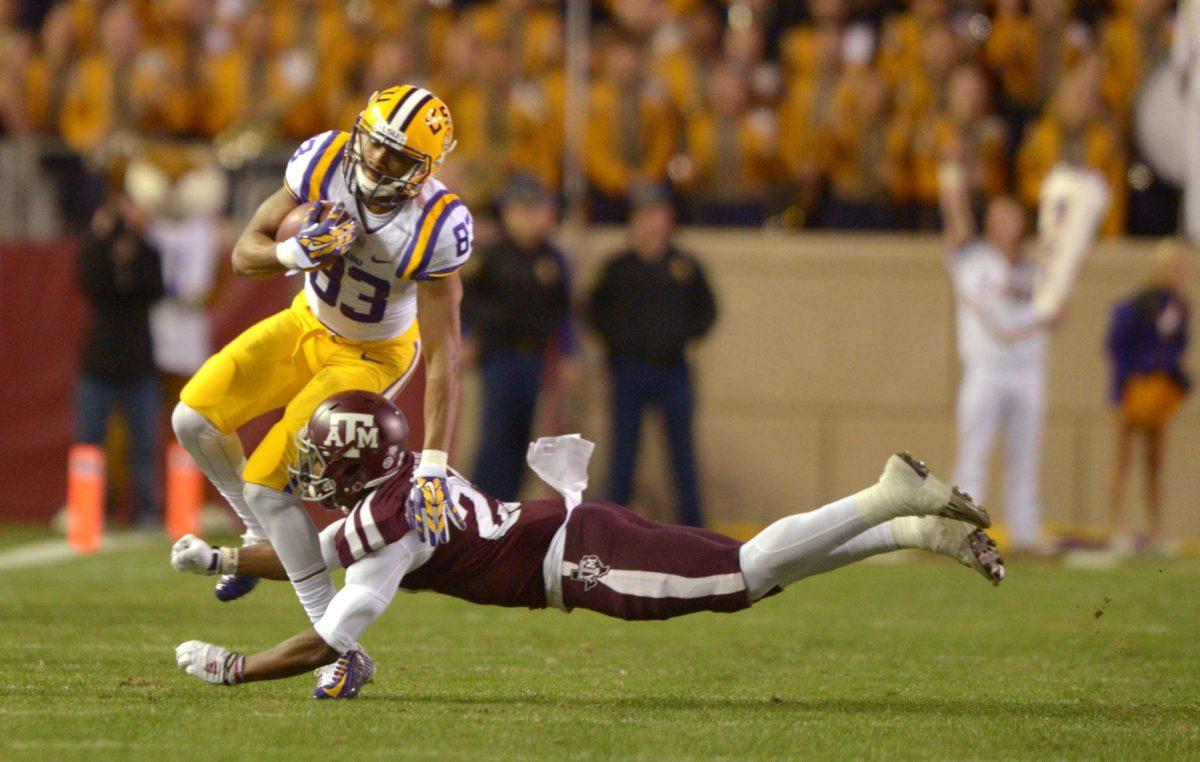 Texas A&amp;M freshman defensive back Armani Watts (23) attempts to tackle LSU sophomore wide receiver Travin Dural (83) during the Tigers' 23-17 victory on Thursday, Nov.27, 2014 in Kyle field.