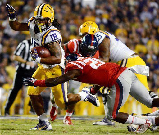 Mississippi defensive back Mike Hilton (28) tackles LSU running back Terrence Magee (18) during an NCAA college football game in Baton Rouge, La., Saturday Oct. 25, 2014. LSU won 10-7. (AP Photo/The Daily Mississippian, Payton Teffner)