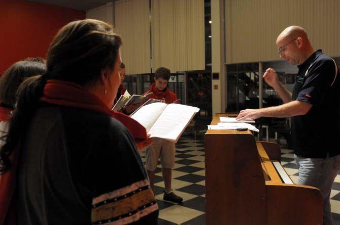 Lance Parker leads Theatre Baton Rouge carolers Monday, Nov. 24 during rehearsal.