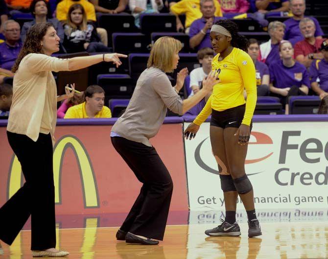 LSU volleyball team head coach Fran Flory associate head coach and Jill Lytle Wilson instruct players during Tiger's victory 3-2 against Arkansas Sunday, October 5, 2014 in the PMAC.