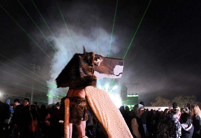 Festival goer walks on stilts in costume near Le Plur stage at VooDoo Fest Sunday, November 2, 2014 in New Orleans.