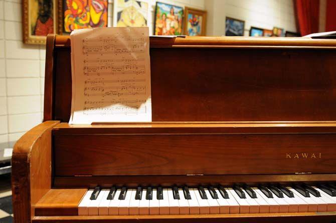 Sheet music sits on the piano before carolers join for rehearsal at Theatre Baton Rouge.