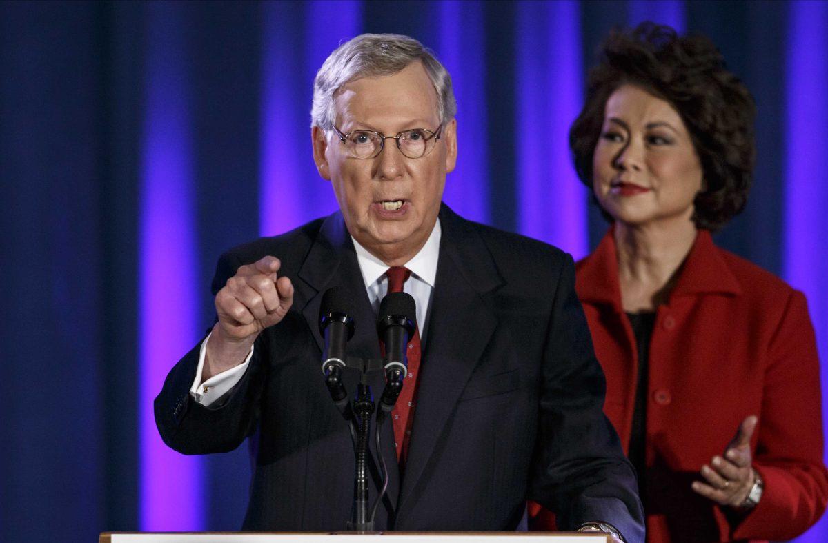 Senate Minority Leader Mitch McConnell of Ky., joined by his wife, former Labor Secretary Elaine Chao, celebrates with his supporters at an election night party in Louisville, Ky.,Tuesday, Nov. 4, 2014. McConnell won a sixth term in Washington, with his eyes on the larger prize of GOP control of the Senate. The Kentucky Senate race, with McConnell, a 30-year incumbent, fighting off a spirited challenge from Democrat Alison Lundergan Grimes, has been among the most combative and closely watched contests that could determine the balance of power in Congress. (AP Photo/J. Scott Applewhite)