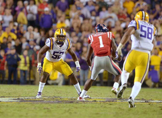 LSU sophomore linebacker Kendell Beckwith (52) prepares to tackle Ole Miss wide receiver Larguon Treadwell during Tigers' 10-7 victory Saturday, October 25, 2014 in the Tiger Stadium.