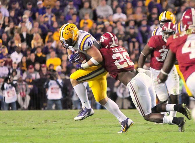 LSU senior tight end Travis Dickson (41) fights off an Alabama defender Saturday, Nov. 8, 2014 during the Tigers' 20-13 loss against the Crimson Tide in Tiger Stadium.