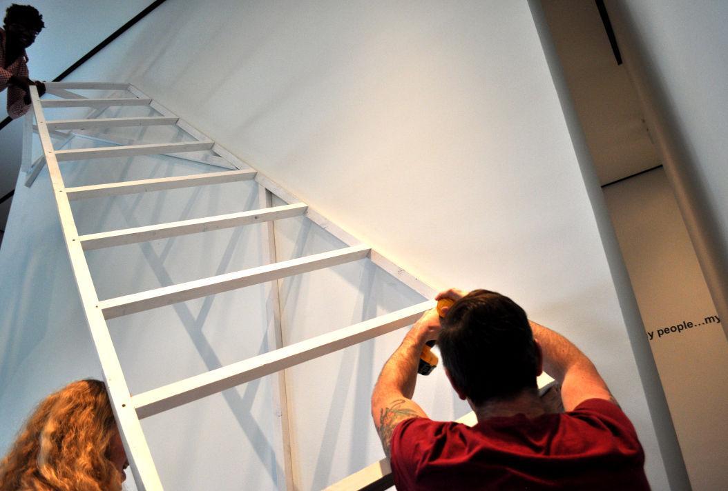 Local artist Silas Breaux works on his new installation, Dwelling, at the LSU Museum of Art on Wednesday.